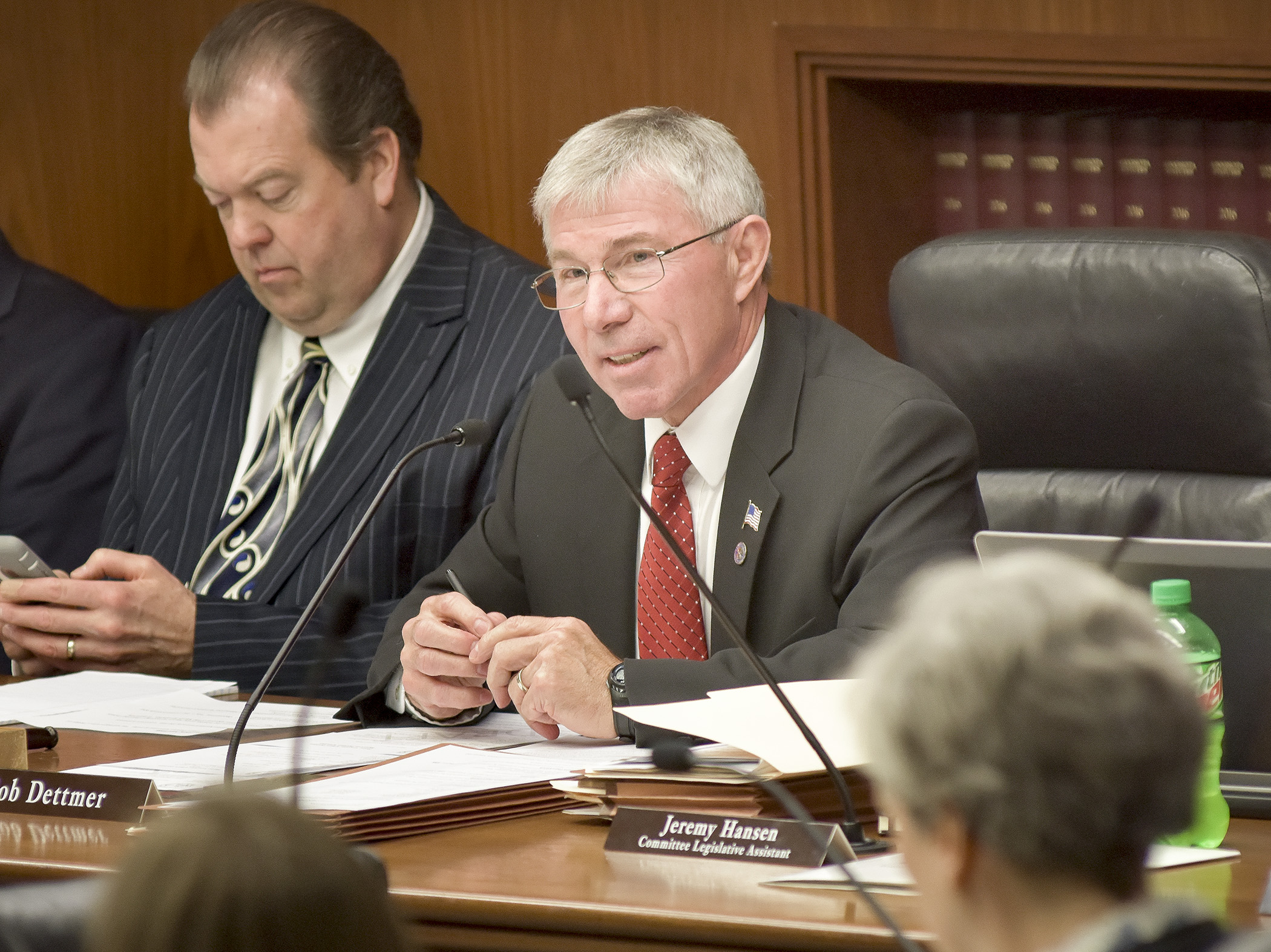 Rep. Bob Dettmer, chair of the House Veterans Affairs Division, reviews the division report before its approval March 13. Photo by Andrew VonBank